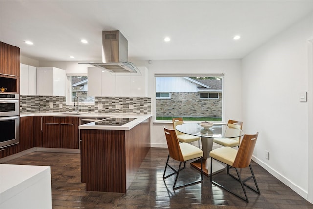 10134 Eddystone Dr, Houston, TX 77043 - kitchen with a peninsula, island exhaust hood, a sink, modern cabinets, and light countertops