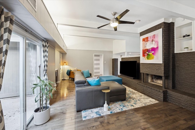 10134 Eddystone Dr, Houston, TX 77043 - living room featuring hardwood / wood-style floors, a brick fireplace, built in features, and ceiling fan
