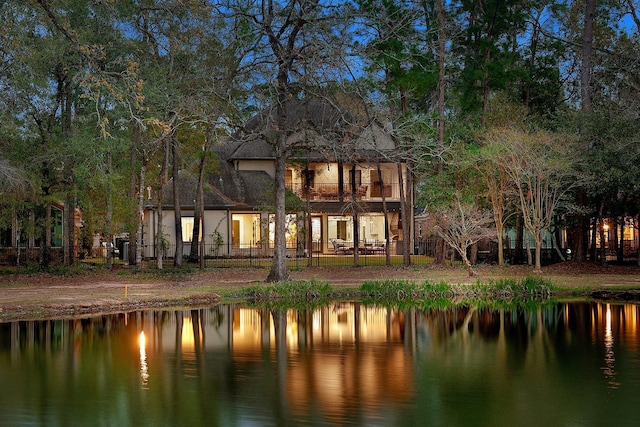 rear view of house featuring a water view