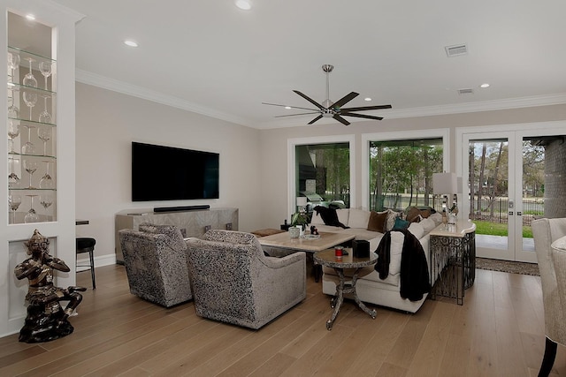 living room featuring ornamental molding, recessed lighting, a ceiling fan, and light wood-type flooring