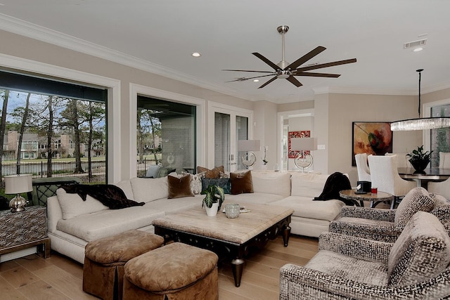 living area featuring light wood-type flooring, visible vents, recessed lighting, ceiling fan, and crown molding