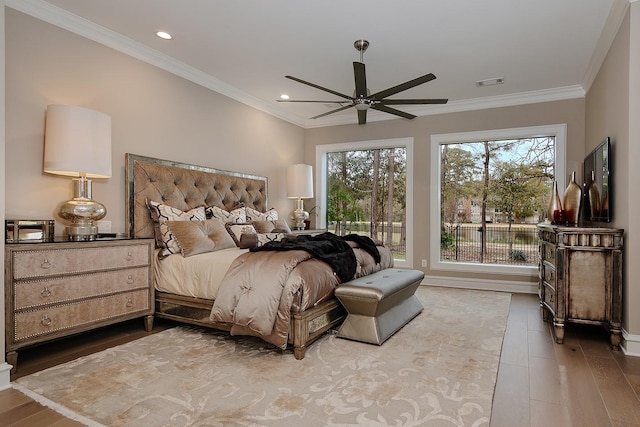 bedroom featuring wood finished floors, baseboards, ornamental molding, visible vents, and recessed lighting
