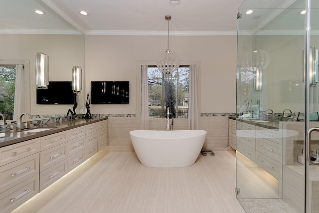 bathroom featuring a stall shower, tile walls, an inviting chandelier, a freestanding tub, and vanity