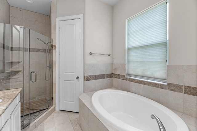 full bath with a bath, tile patterned floors, vanity, and a stall shower