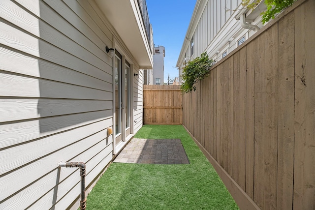 view of yard featuring fence and a patio area