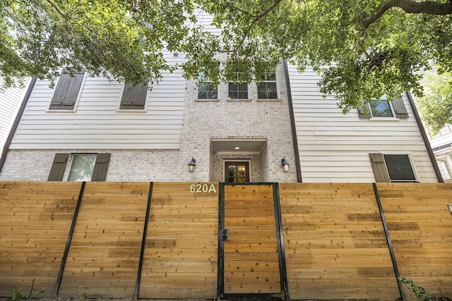 rear view of property with fence