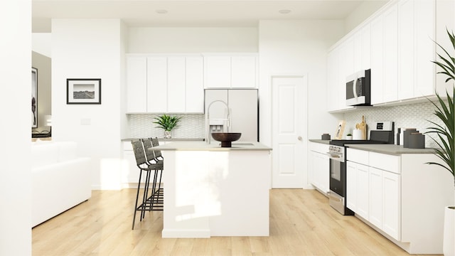 kitchen with backsplash, light wood-style floors, and white appliances
