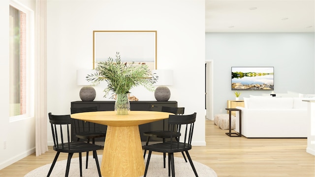 dining room featuring baseboards and light wood-style flooring