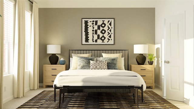 bedroom with light carpet and baseboards
