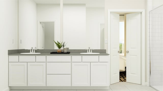 bathroom featuring tile patterned flooring, a sink, double vanity, and tiled shower