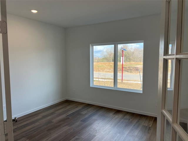 unfurnished room featuring recessed lighting, baseboards, and dark wood-style floors