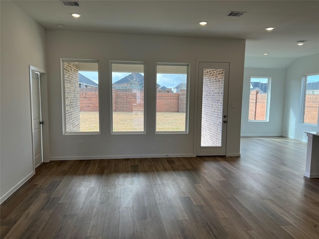 interior space with baseboards, visible vents, dark wood-style floors, and recessed lighting
