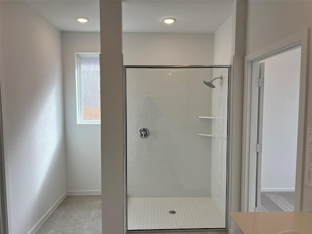 bathroom featuring baseboards and a stall shower