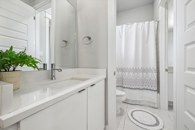 full bath with toilet, vanity, and tile patterned floors