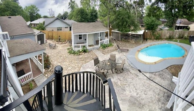 15907 Whispering Falls Ct, Houston, TX 77084 - view of pool with a fenced backyard, an outbuilding, and a patio area
