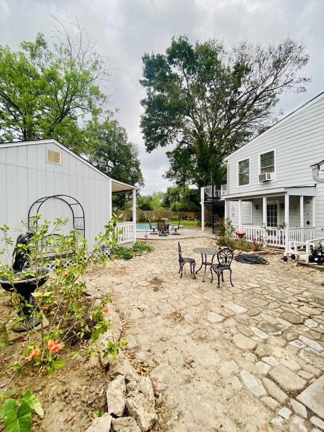 15907 Whispering Falls Ct, Houston, TX 77084 - view of yard featuring a patio, a deck, a pool, fence, and cooling unit
