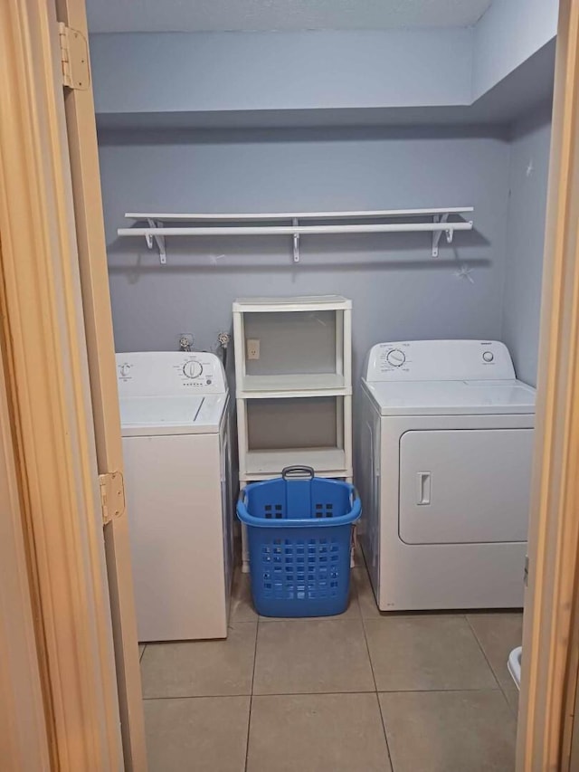 15907 Whispering Falls Ct, Houston, TX 77084 - laundry room with light tile patterned flooring and washer and clothes dryer