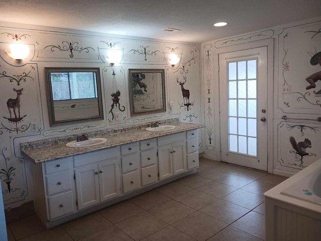 15907 Whispering Falls Ct, Houston, TX 77084 - bathroom featuring wallpapered walls, double vanity, and tile patterned floors