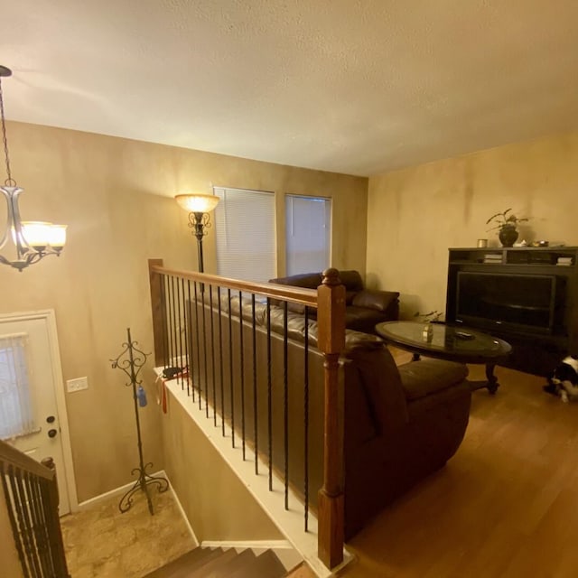15907 Whispering Falls Ct, Houston, TX 77084 - living room with wood finished floors, a chandelier, and a textured ceiling