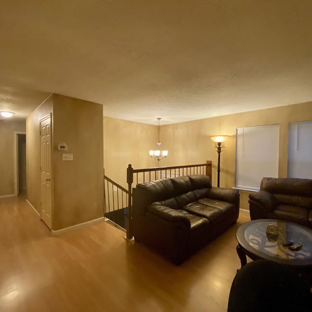 15907 Whispering Falls Ct, Houston, TX 77084 - living room featuring wood finished floors, a chandelier, and baseboards