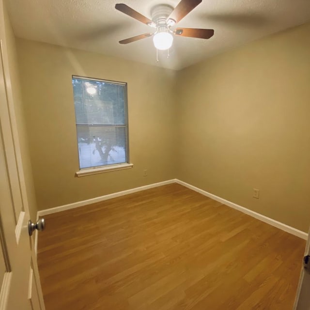 15907 Whispering Falls Ct, Houston, TX 77084 - empty room featuring wood finished floors, baseboards, ceiling fan, and a textured ceiling