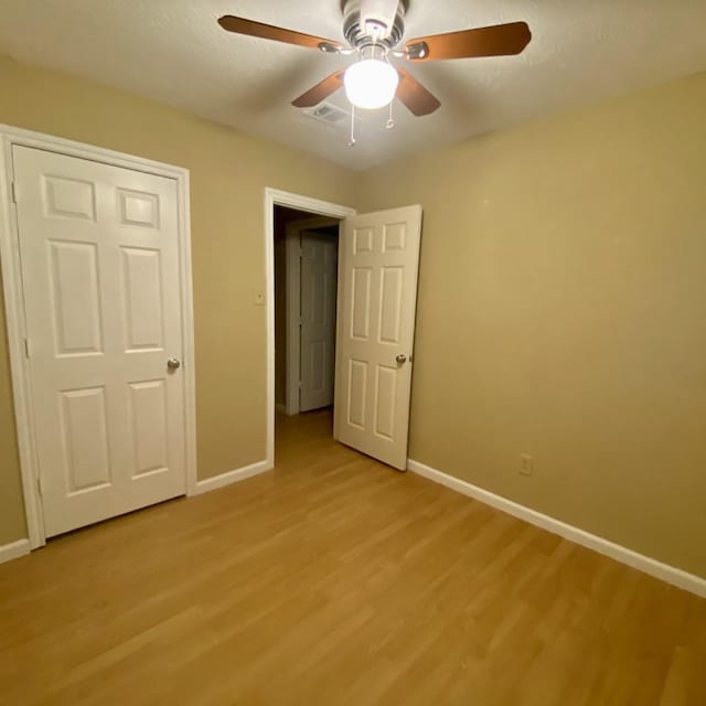 15907 Whispering Falls Ct, Houston, TX 77084 - unfurnished bedroom with baseboards, light wood-type flooring, and ceiling fan
