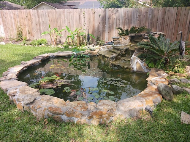 15907 Whispering Falls Ct, Houston, TX 77084 - view of yard featuring a garden pond and fence