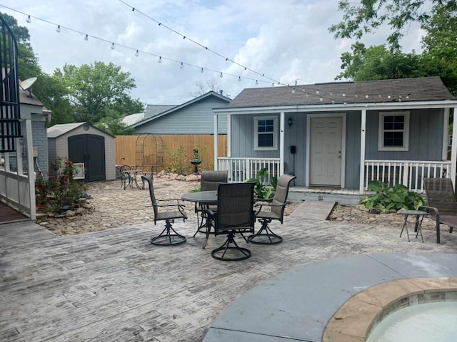 15907 Whispering Falls Ct, Houston, TX 77084 - covered porch featuring a storage shed and outdoor dining space