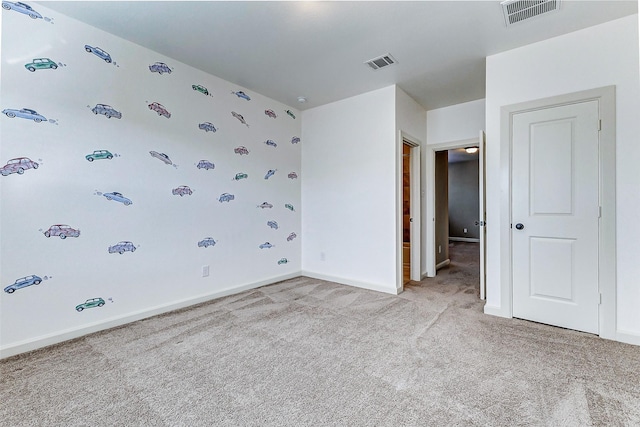unfurnished bedroom with visible vents, baseboards, and light carpet