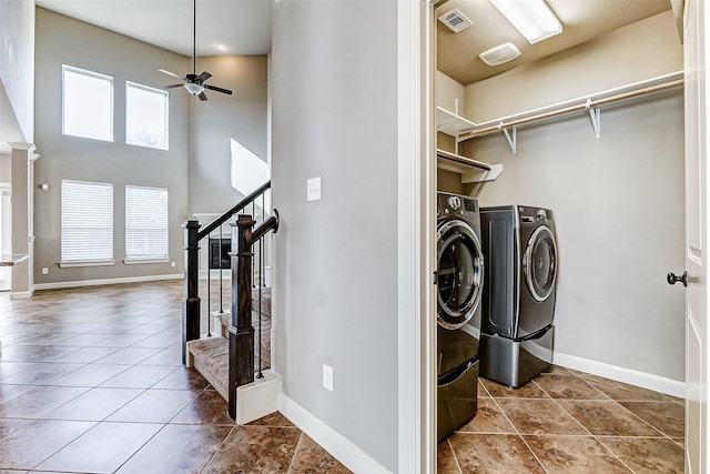 clothes washing area featuring visible vents, a ceiling fan, washer and dryer, and a healthy amount of sunlight
