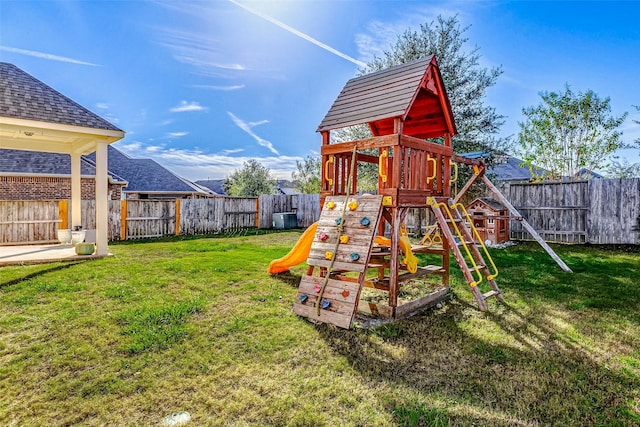 view of jungle gym with a fenced backyard and a yard