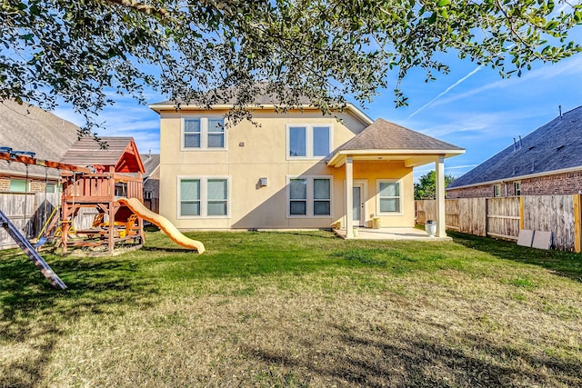 back of house with a patio area, a fenced backyard, a playground, and stucco siding