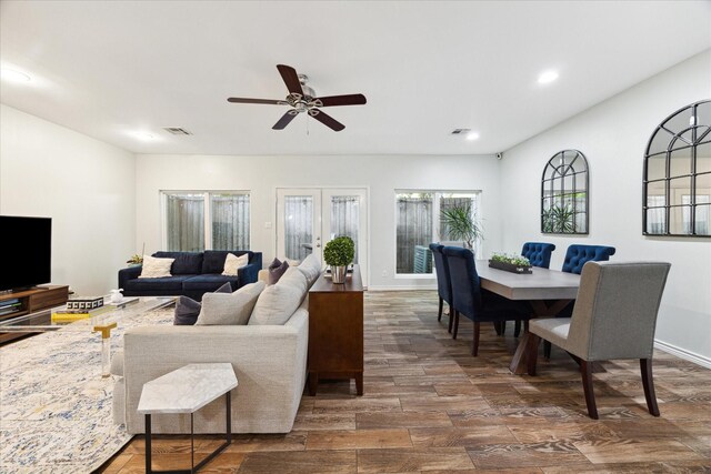 living room with dark wood-style flooring, a ceiling fan, visible vents, and recessed lighting