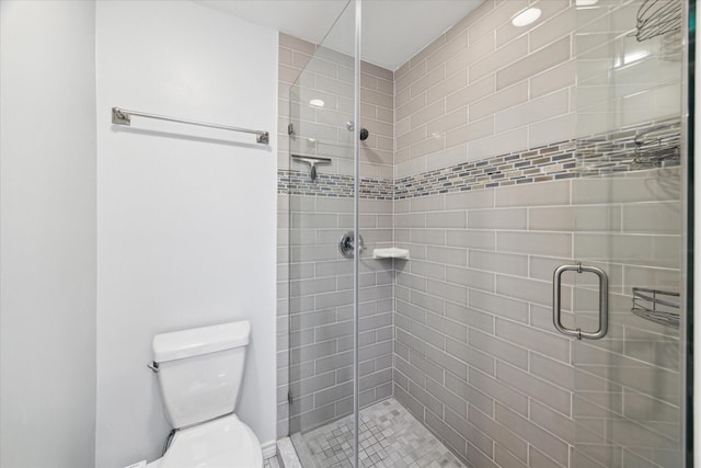 full bathroom featuring toilet and a stall shower