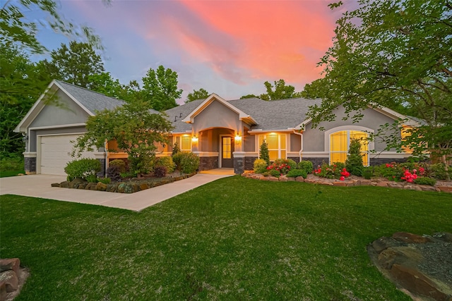 395 Rd 660, Dayton, TX 77535 - view of front of house featuring stone siding, stucco siding, a front lawn, and an attached garage