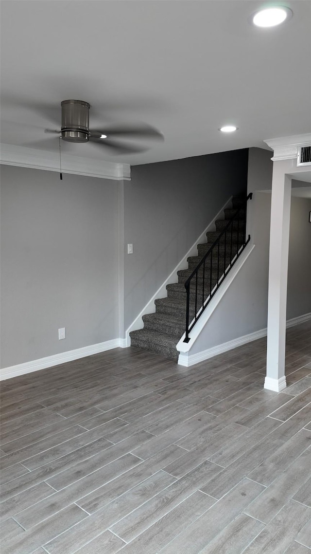 finished basement with visible vents, baseboards, recessed lighting, stairway, and wood finished floors