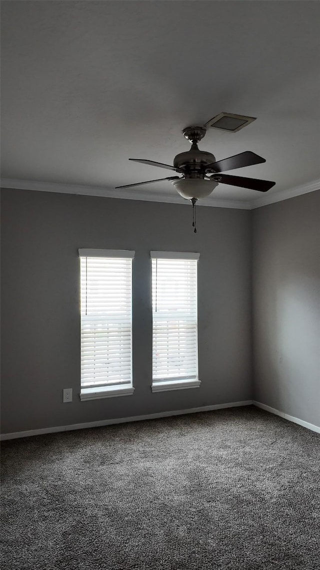 empty room with a ceiling fan, baseboards, ornamental molding, and carpet floors
