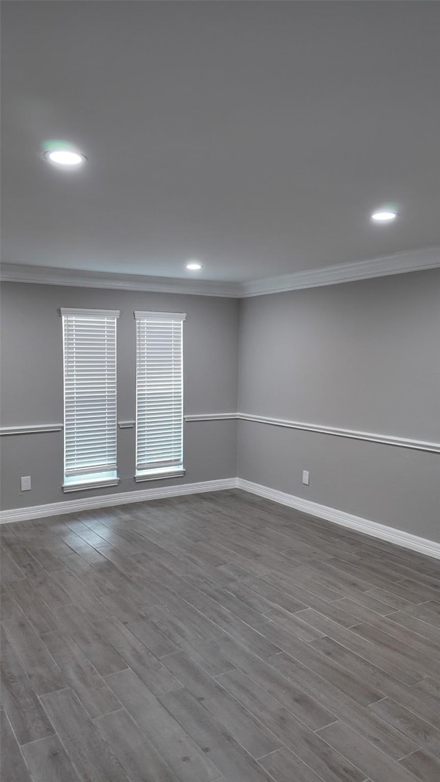 unfurnished room featuring crown molding, baseboards, recessed lighting, and wood finished floors