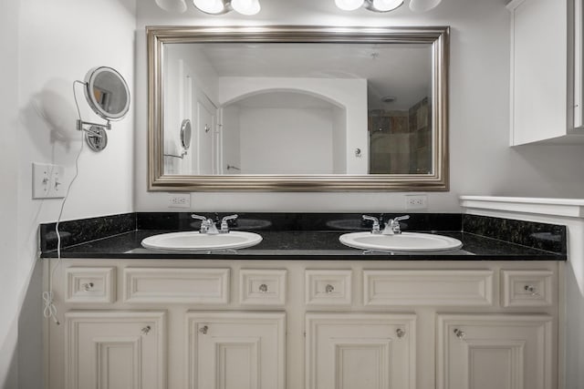full bath with double vanity and a sink