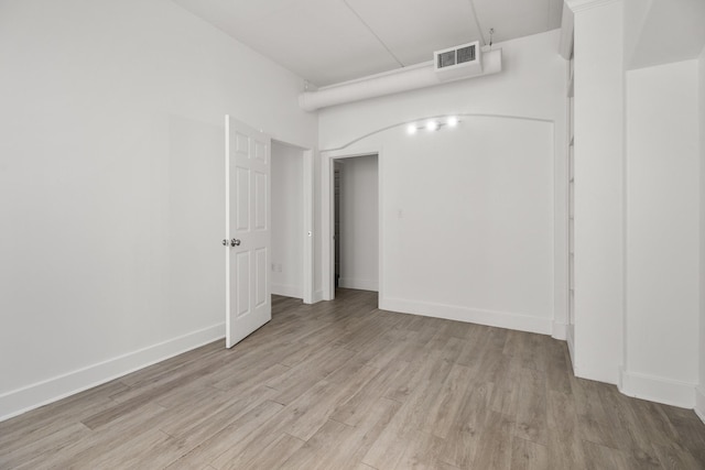 interior space featuring baseboards, light wood-style floors, and visible vents