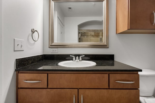 full bath with visible vents, toilet, and vanity