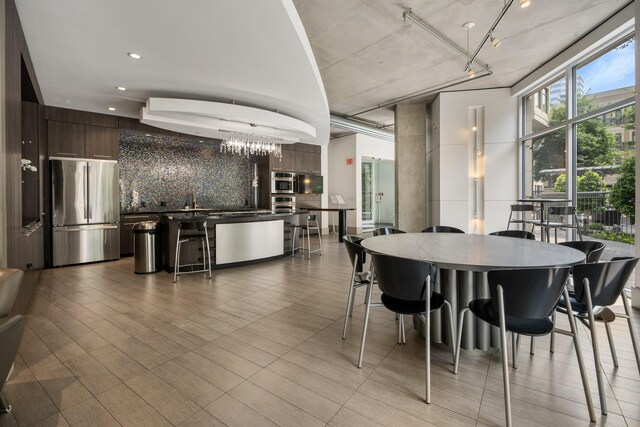 dining area with an inviting chandelier, wood finished floors, and recessed lighting