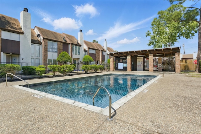 community pool with fence and a residential view