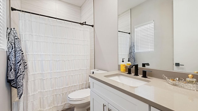 bathroom with vanity, toilet, and curtained shower