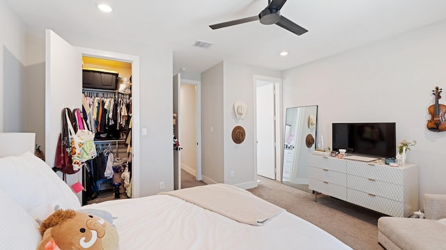 carpeted bedroom featuring ceiling fan, visible vents, baseboards, recessed lighting, and a spacious closet