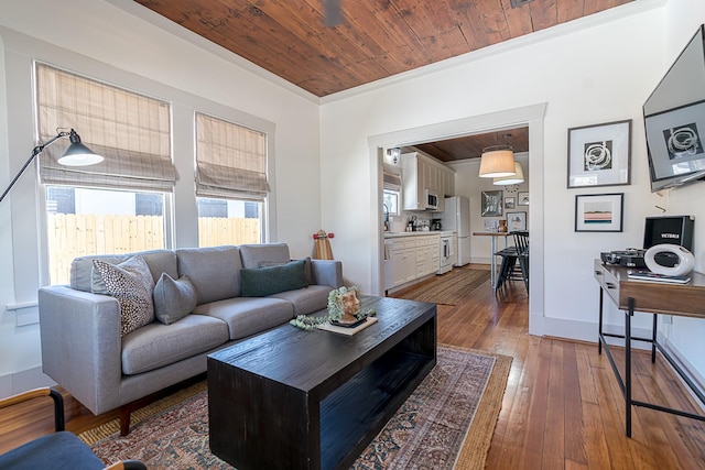 3825 Avenue N 1/2 Ave N Unit 1/2, Galveston, TX 77550 - living area featuring wood-type flooring, baseboards, wooden ceiling, and ornamental molding
