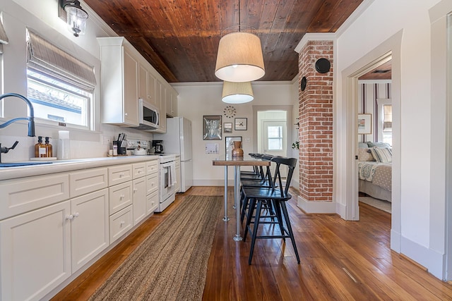 3825 Avenue N 1/2 Ave N Unit 1/2, Galveston, TX 77550 - kitchen featuring a sink, dark wood-type flooring, white appliances, a wealth of natural light, and wood ceiling