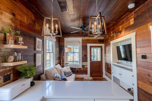 3825 Avenue N 1/2 Ave N Unit 1/2, Galveston, TX 77550 - interior space with wood ceiling, wood walls, visible vents, and ceiling fan with notable chandelier