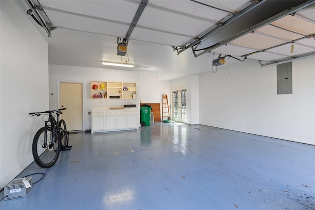 garage with a garage door opener, french doors, electric panel, and baseboards