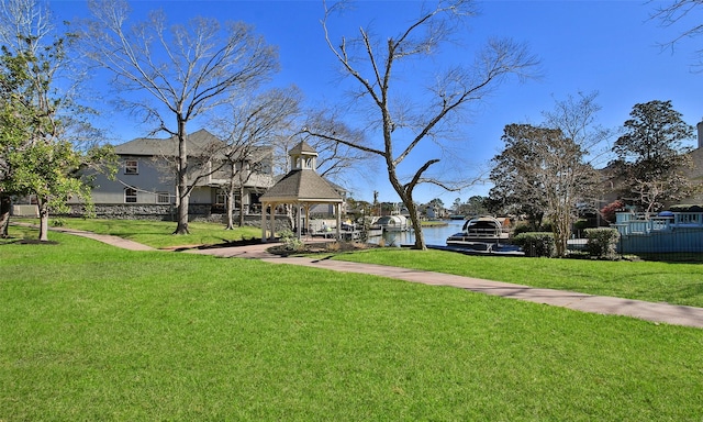 view of yard with a gazebo, a water view, and fence